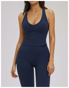 Close-up of deep blue matte yoga set featuring a V-neck tank top and high-waisted leggings