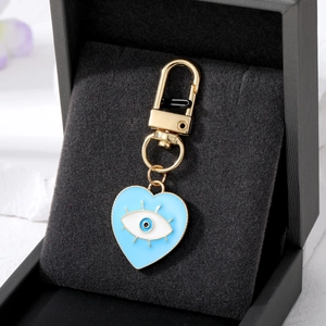Golden heart-shaped devil eye pendant with blue enamel finish in black jewelry box
