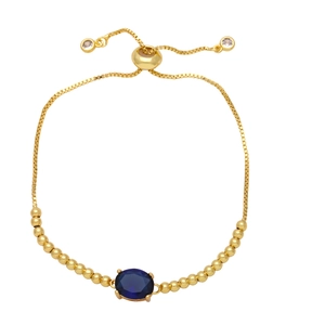 Adjustable gold bracelet featuring an oval blue zircon stone and elegant beads