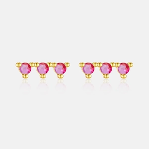 Detail of s925 silver stud earrings with pink zircon stones and gold finish