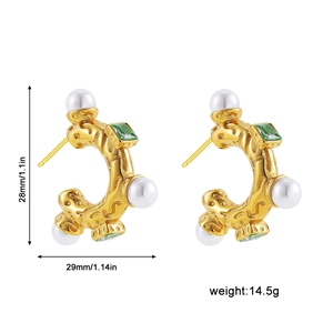 Detailed size view of gold C-shape earrings with white pearls and green square gems