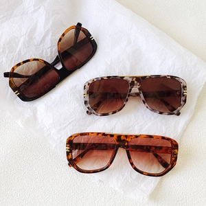 Three pairs of trendy oval tortoiseshell sunglasses with gradient lenses and gold accents