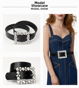 Detailed view of women's black belt featuring a square buckle with sparkling rhinestones