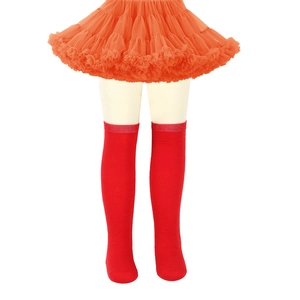 Detail of red over-the-knee socks for girls paired with a layered orange tulle tutu skirt
