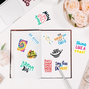 Detail of colorful inspirational stickers with Dream Big text on a minimalist workspace