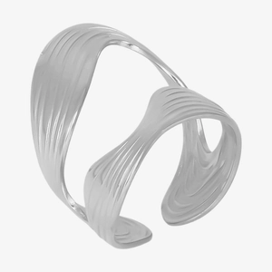 Detail of silver wavy wide band bracelet with sleek minimalist layered design and metallic finish