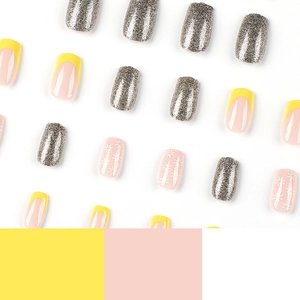 Yellow French press on nails set with white daisy floral prints and silver glitter accents