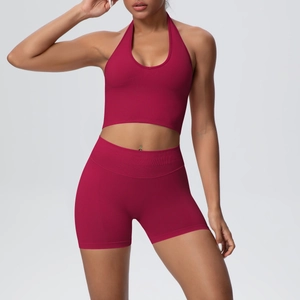 Detail of deep red seamless ribbed yoga set with halter sports bra and high waist shorts