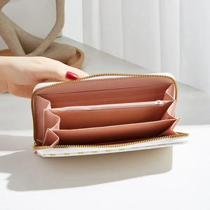 White floral long wallet with gold zipper and pink interior compartments for cards
