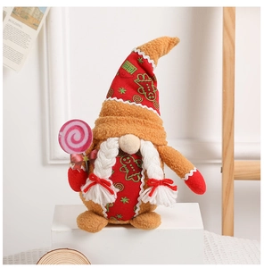 Detail of Christmas gnome plush with gingerbread man print and lollipop accessory