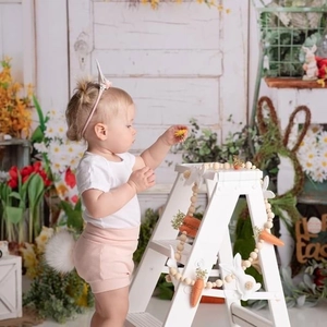 Toddler Easter Bunny outfit with pink unicorn headband and shorts in a festive setting