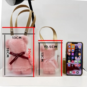Pink coral fleece bear towel sets in two sizes compared with a mobile phone