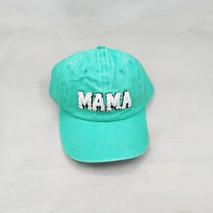 Detail view of MAMA towel embroidery on mint green cotton canvas baseball cap
