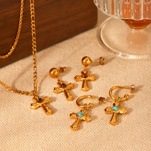 Golden jewelry set with cross pendants featuring turquoise and tiger eye stone inlay