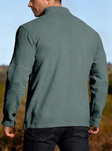 Close-up back view of men's gray fleece quarter-zip sweatshirt in outdoor nature setting
