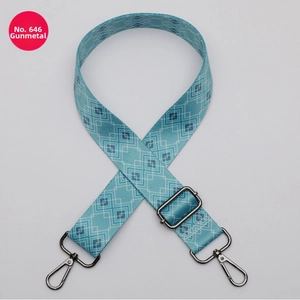 Close-up of 38mm wide turquoise bag strap with white geometric patterns and gunmetal hooks