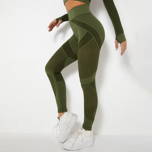 Detail view of olive green high waist yoga pants showing mesh splicing and ribbed texture