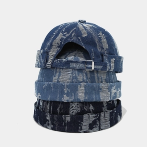 Detail of three washed denim miki hats with vintage distressed texture and metal buckles