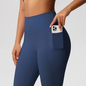 Detail of high-waisted yoga leggings in dark blue featuring a functional side phone pocket