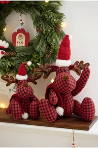 Detailed close-up of red and black buffalo plaid Christmas reindeer dolls with Xmas decor