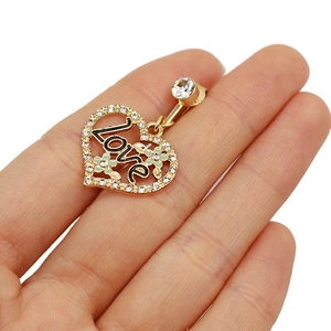 Detailed macro shot of a gold heart belly ring with Love letters and blue floral inlay