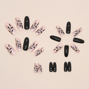 Oval black silhouette leaf press-on nails with elegant pink and black art patterns