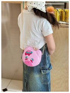 Pink cartoon animal silicone crossbody bag for girls with a gold chain strap shown in use
