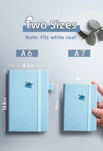 Close-up of A6 and A7 light blue PU leather notebooks with elastic strap and pen loop