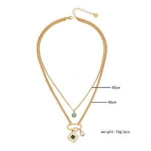 Double layer gold necklace with turquoise pendant and white shell charms on white background