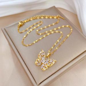 Luxurious gold butterfly necklace with crystal zircon inlays on a jewelry box