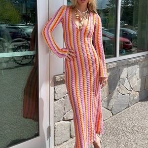 Detailed knit texture and colorful chevron wave pattern on a deep V-neck long sleeve dress