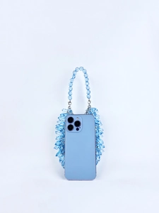 Macro shot of blue crystal acrylic beads detailing the texture of a handmade evening bag
