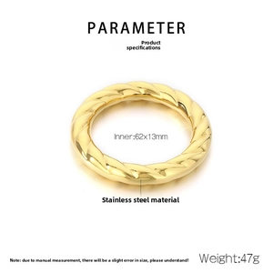 Detail of twisted spiral texture on 18k gold plated hollow stainless steel bangle