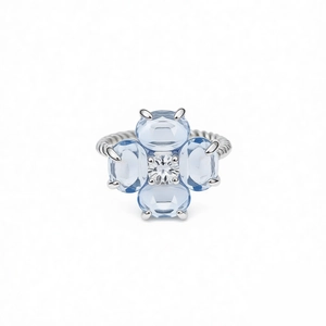 Bague torsadée en argent ornée de fleurs de trèfle en zircon bleu clair sur fond blanc