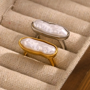 Vintage 18K gold and silver plated stainless steel rings with baroque pearls in a jewelry box