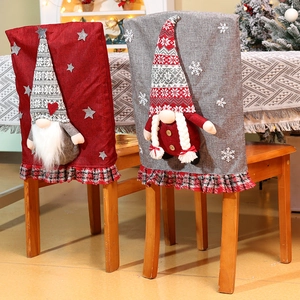 Detail of Christmas chair covers with 3D gnomes, rustic linen texture and plaid ruffles