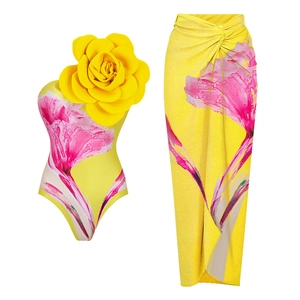 Detail eines gelben One-Shoulder-Badeanzugs und Wickelrock mit 3D-Blume und Blumendruck