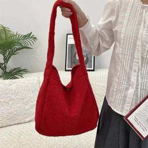 Close-up of bright red boucle tote bag showing soft fuzzy texture and large capacity