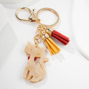 Cute beige cat silhouette keychain with colorful tassels and golden metal ring