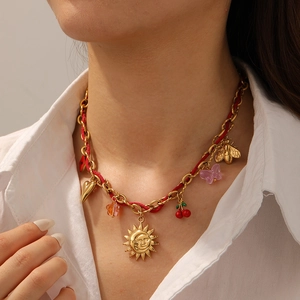 Fashionable gold chain and red rope necklace with cherry, sun, and bee charms