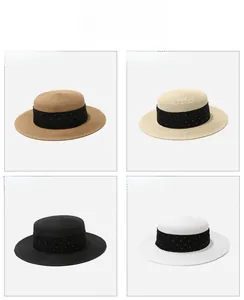 Detailed view of straw boater hats in khaki, beige, black, and white with polka dot ribbons