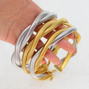 Elegant woven titanium steel bracelet set in gold and silver finish on plain background