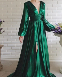 Detail of emerald green satin dress featuring pleated waist and high side slit detail