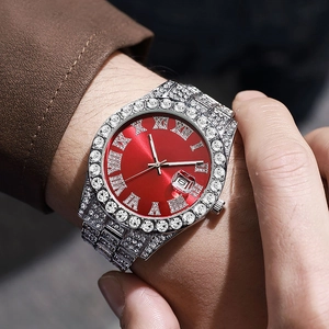 Close-up of luxury iced-out silver watch with red Roman dial and crystal embellishments