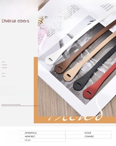 Detail of five slim genuine cowhide leather belts in black, brown, red, white, and khaki