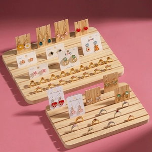 Solid wood jewelry display organizer for rings, earrings, and necklaces on pink background