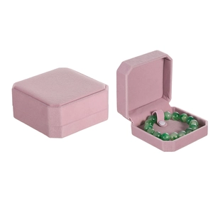 Macro detail of an octagonal pink velvet jewelry box showing interior and exterior