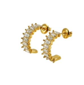 Detailed macro view of U-shaped gold earrings set with rectangular zircon stones