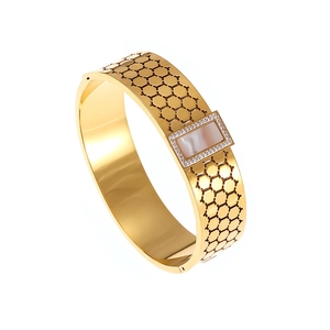 Vintage gold honeycomb bangle with hollow pattern and mother-of-pearl center piece