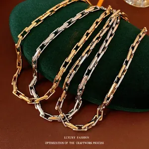 Polished gold and silver mixed color paperclip chain necklace on velvet cushion